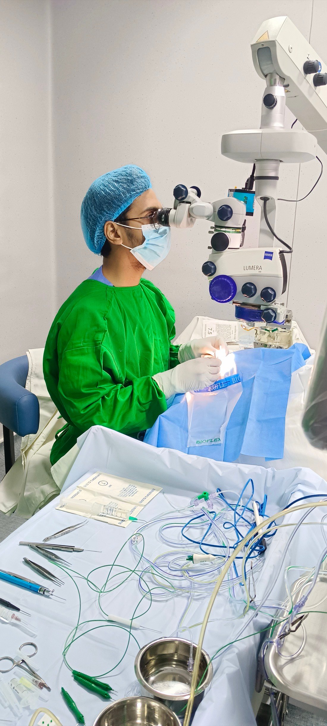 Dr. Harshit Vaidya operating at the surgical microscope
